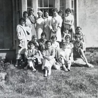 Black and white photo of a group of women gathered outside a Georgian building, Newton Park, 1959