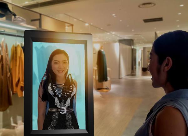 Shopper trying on clothes with an augmented reality smart display