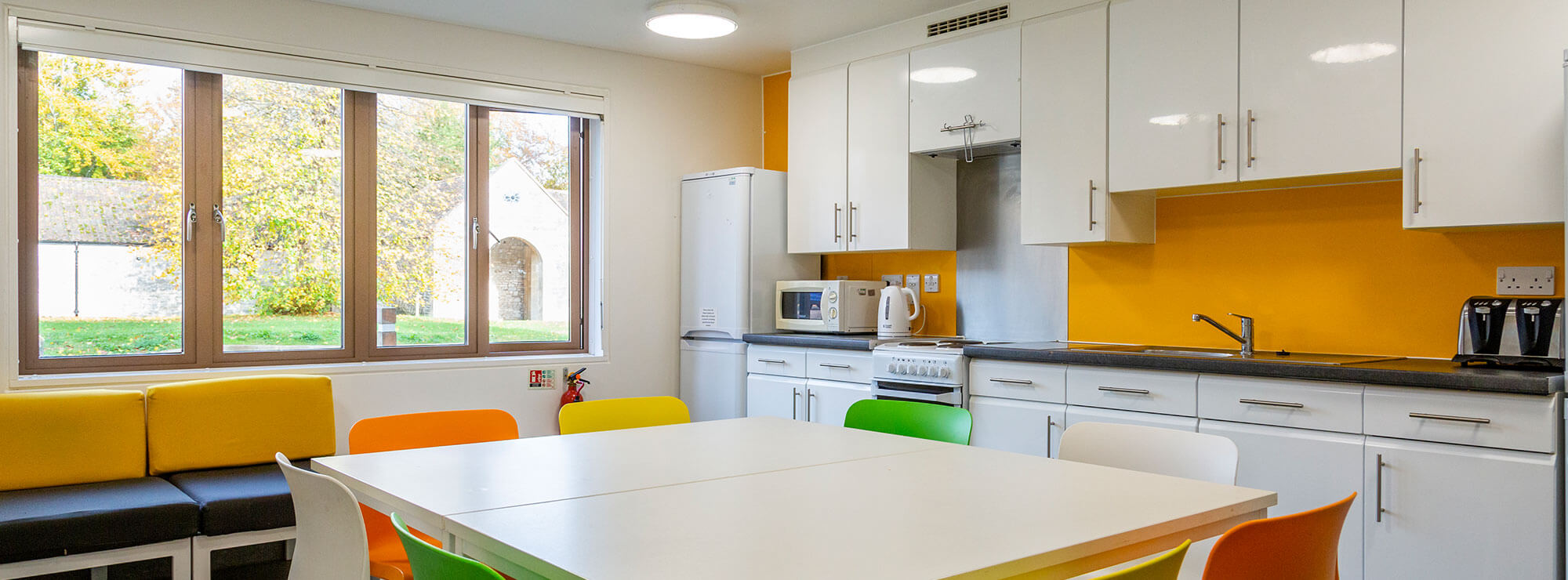 A bright student kitchen with a large window at Newton Park campus