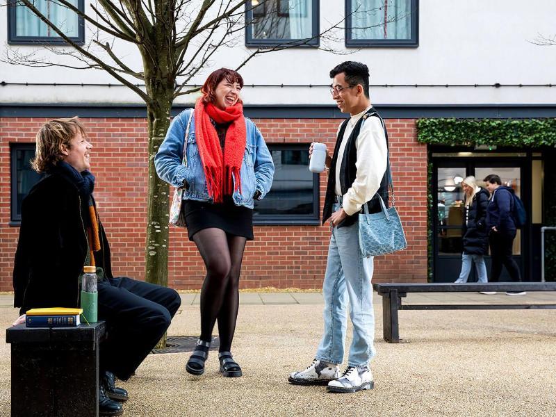 Students chatting in an outdoor courtyard space