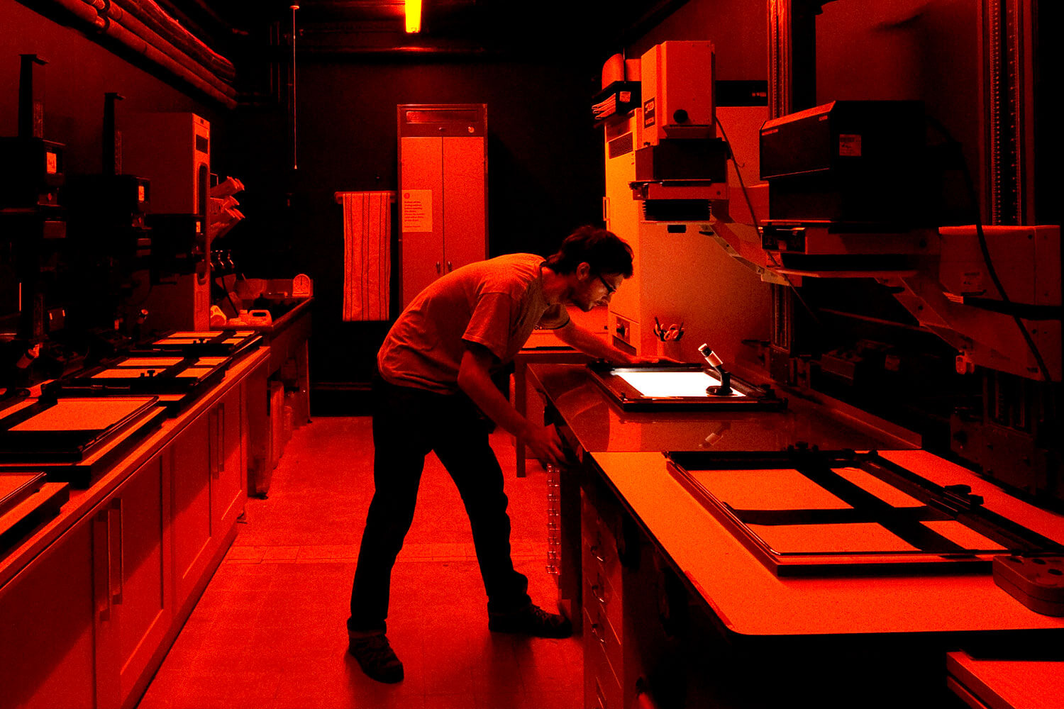 Student working in a darkroom