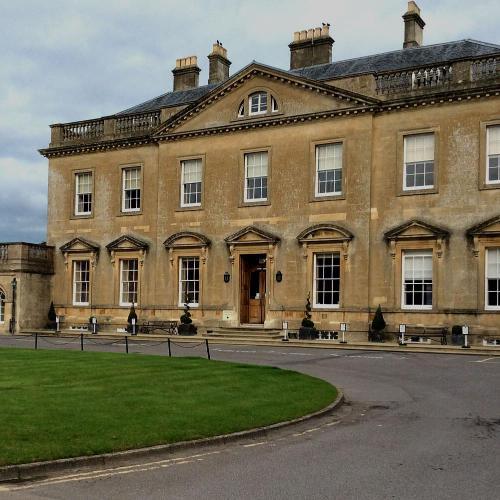 A grand house set against green grass