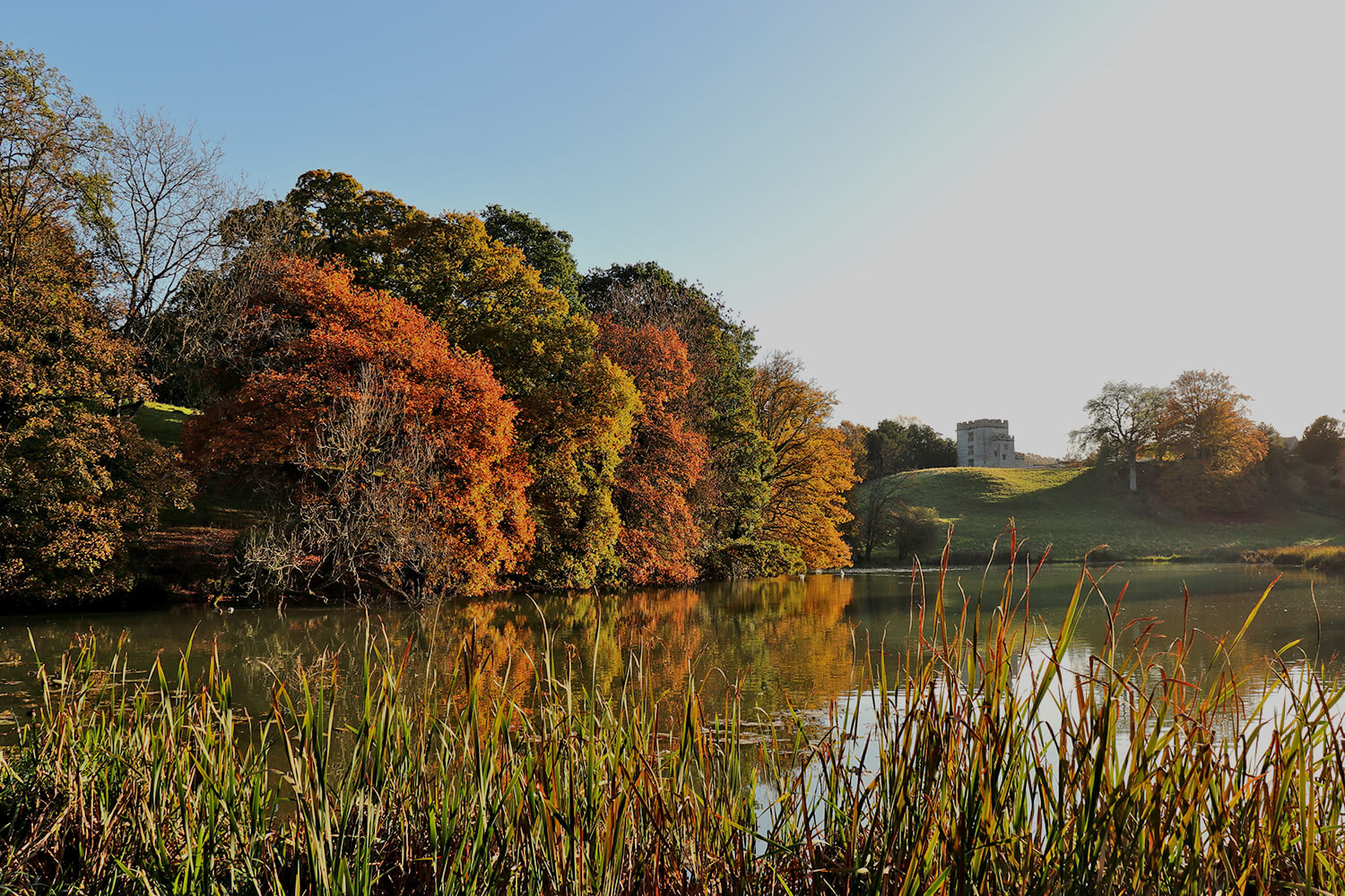 Lake with the castle in the background on a sunny day at Bath Spa campus