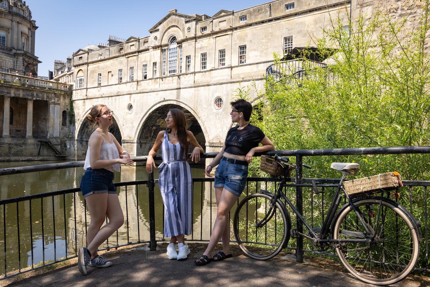 Students standing by Pulteney Bridge in Bath