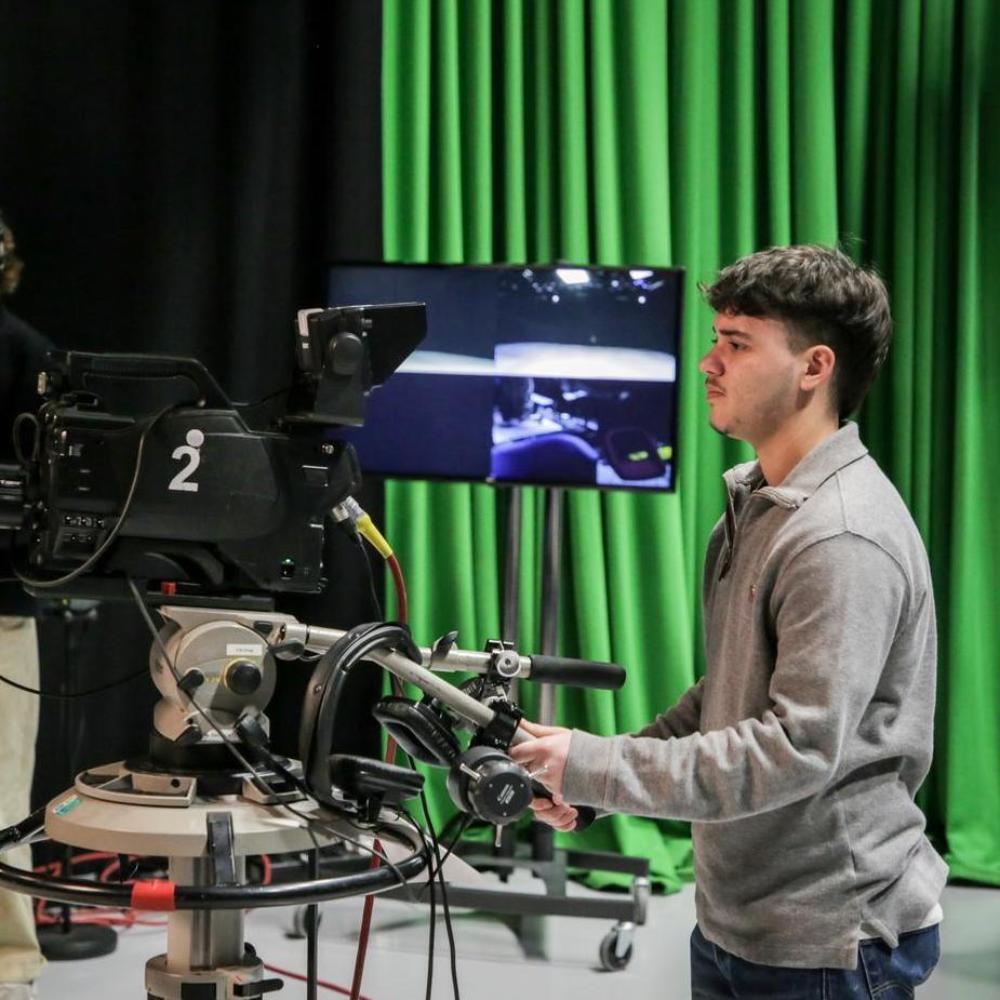 Young man with operating a television camera