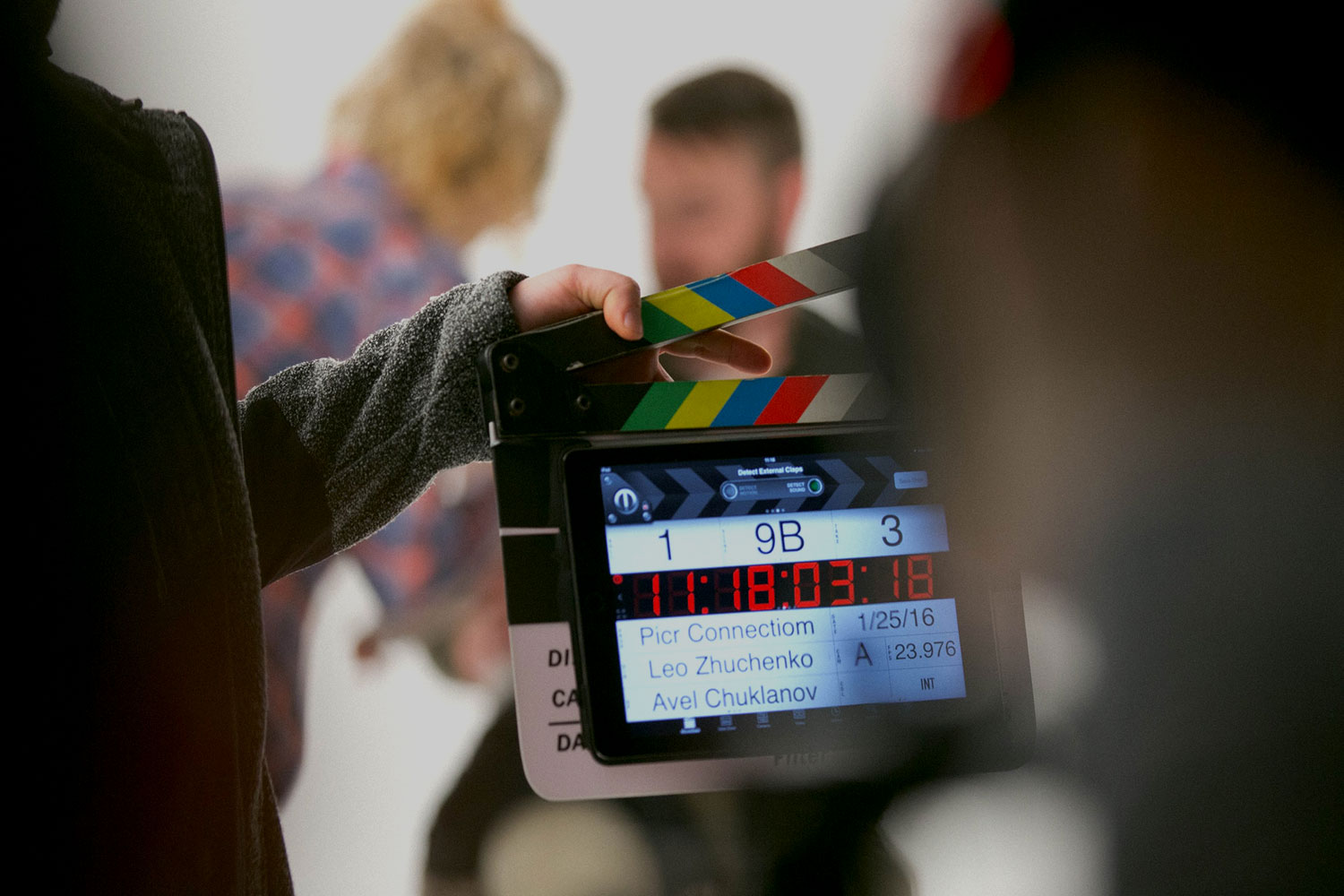 A person holding a clapperboard on a film set