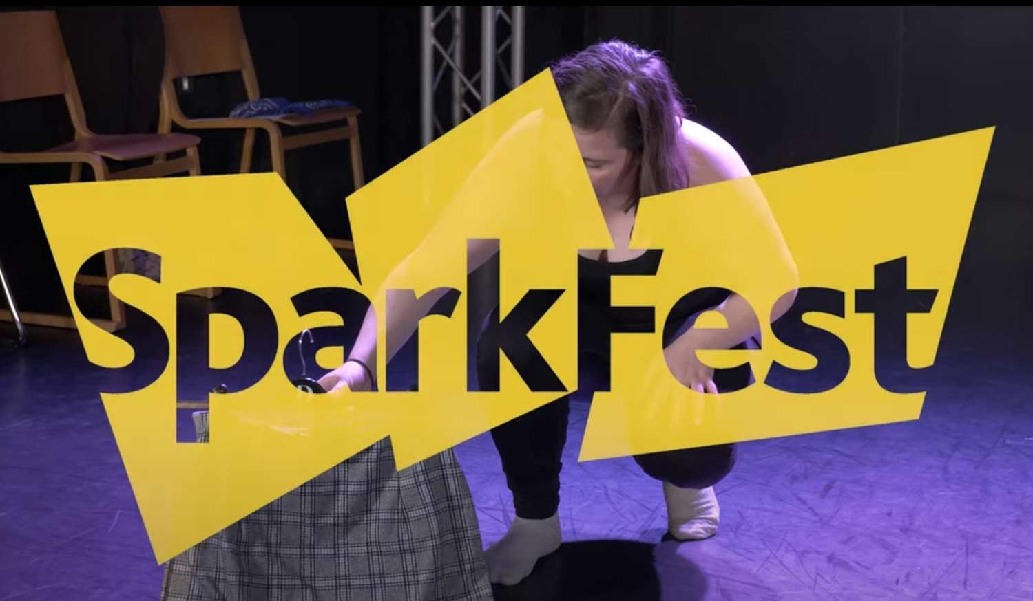 SparkFest logo over an actor on stage