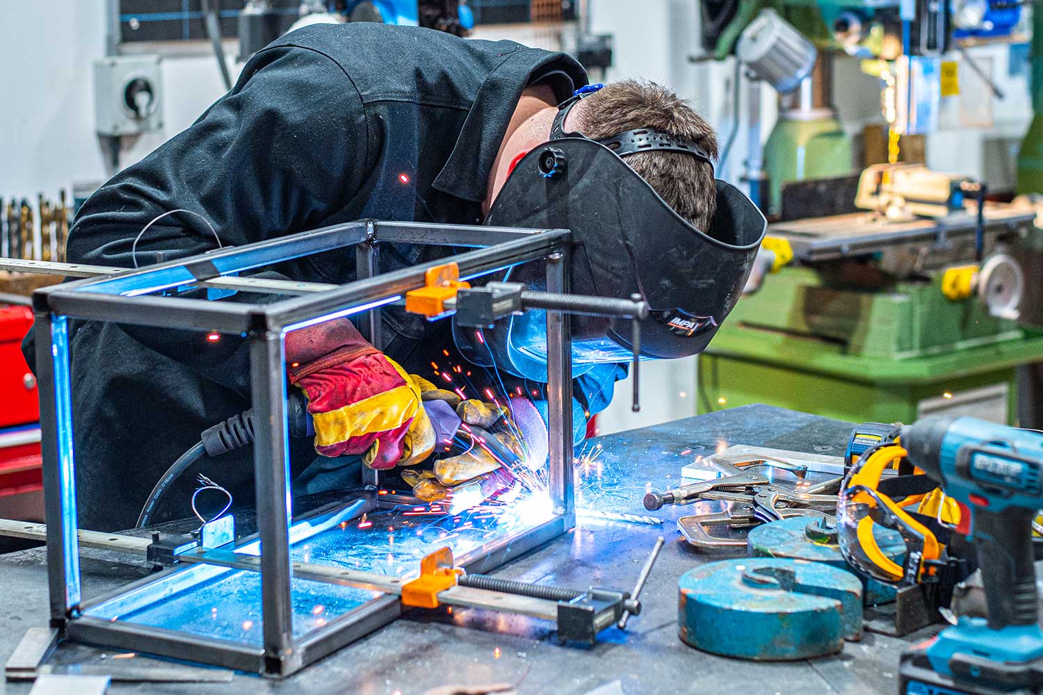 A student using equipment in the metalwork workshop at Locksbrook