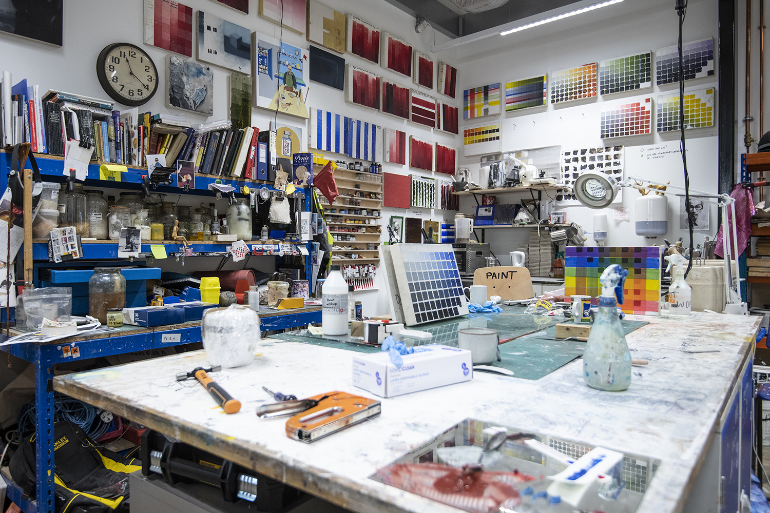 A room full of various paints and painting tools