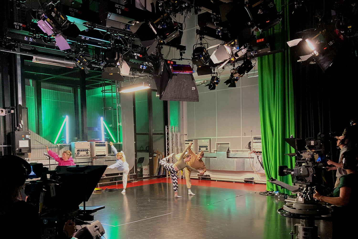 Students in a television studio filming dancers.