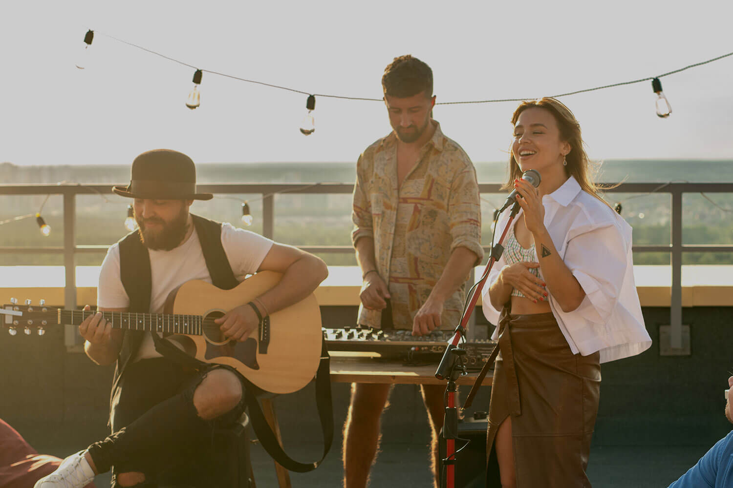Music group performing at a rooftop party