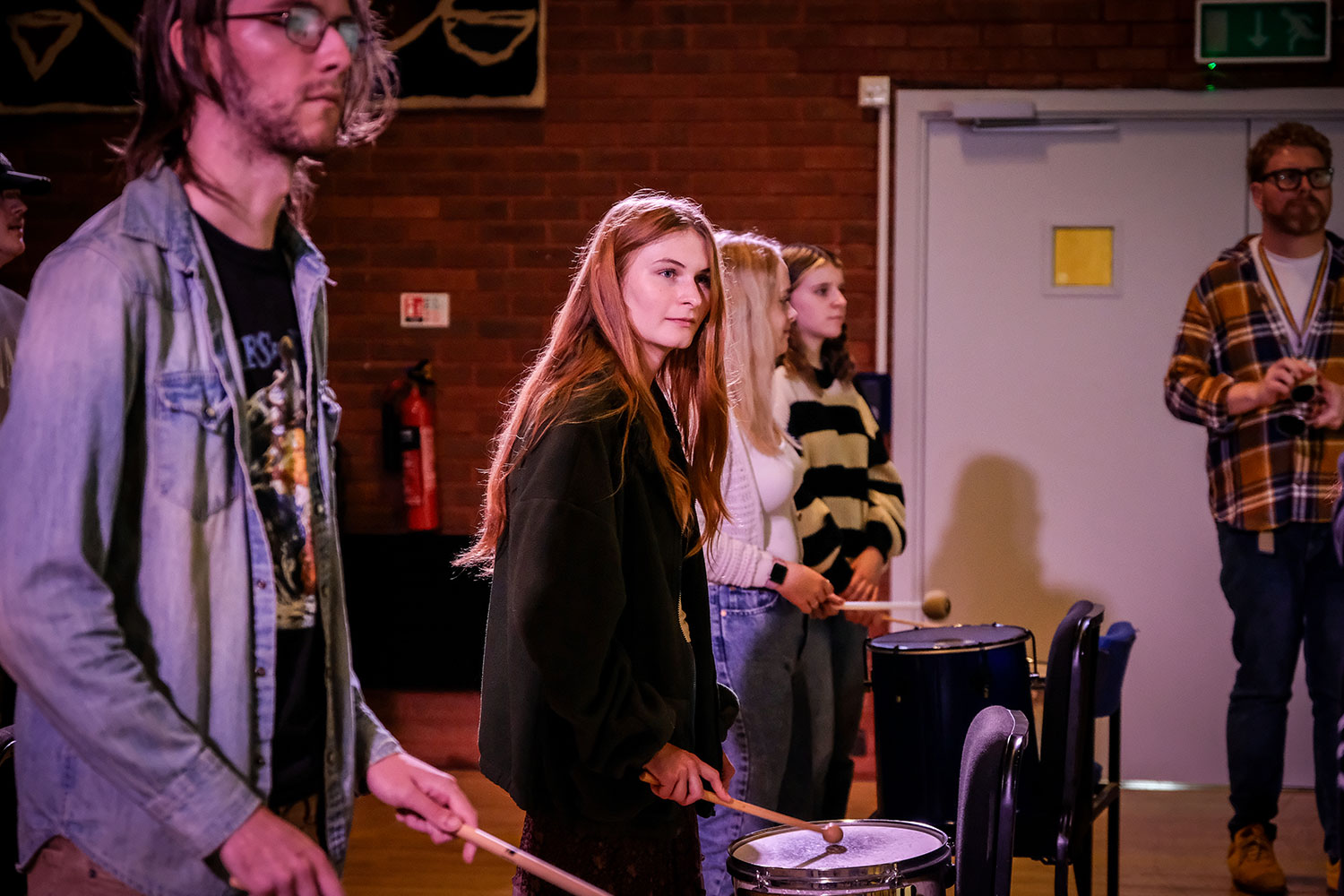 Students with Samba instruments in a theatre