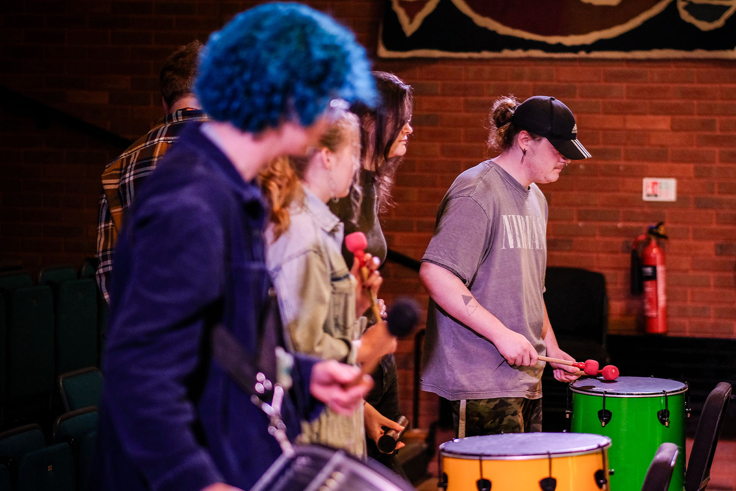 Students with Samba instruments in a theatre