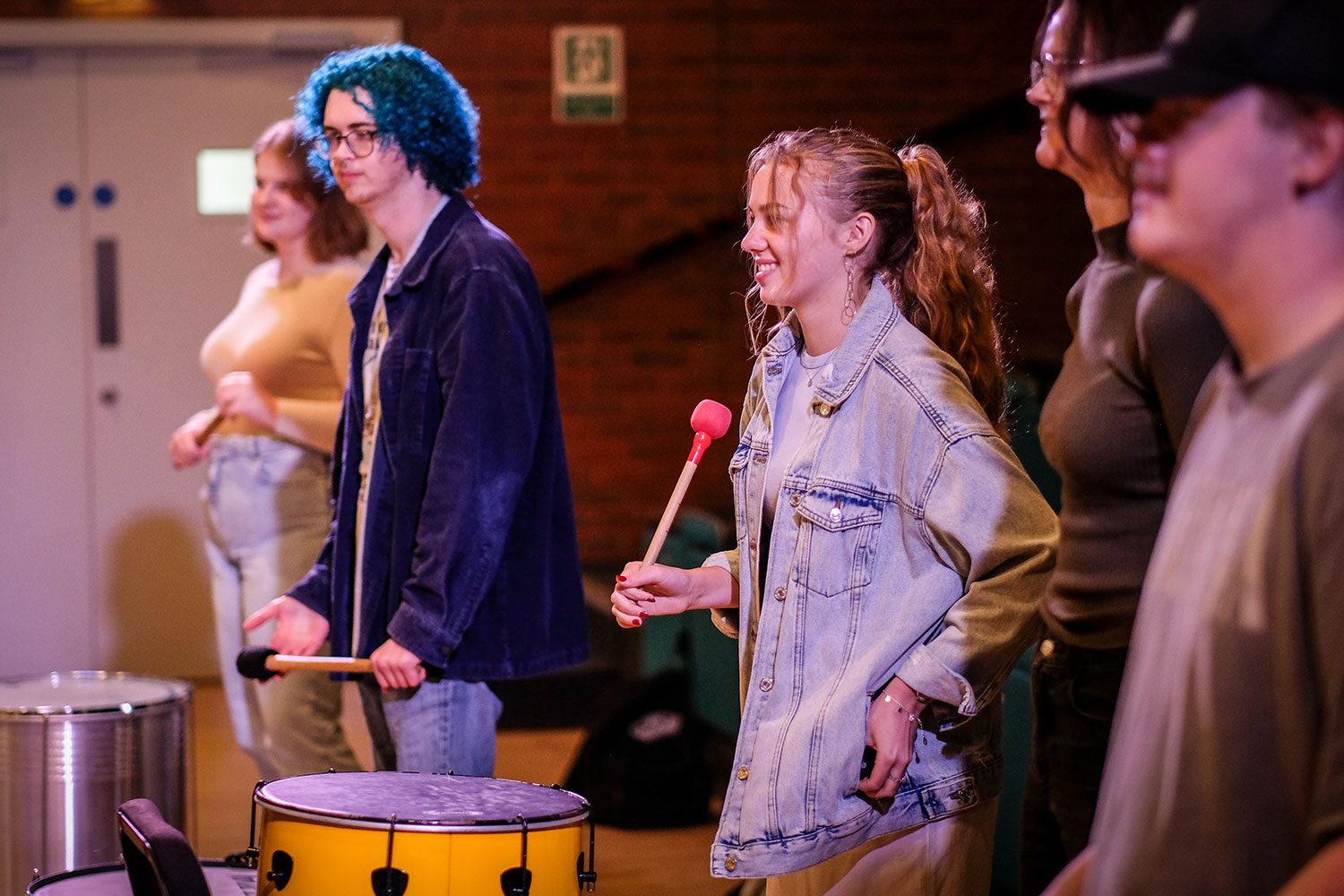 Students with Samba instruments in a theatre