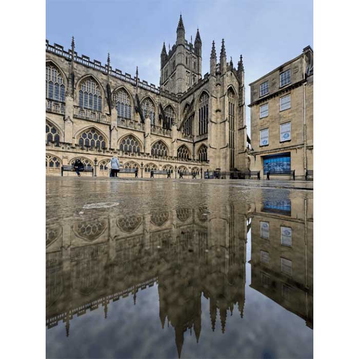 A reflection of Bath Abbey in a puddle