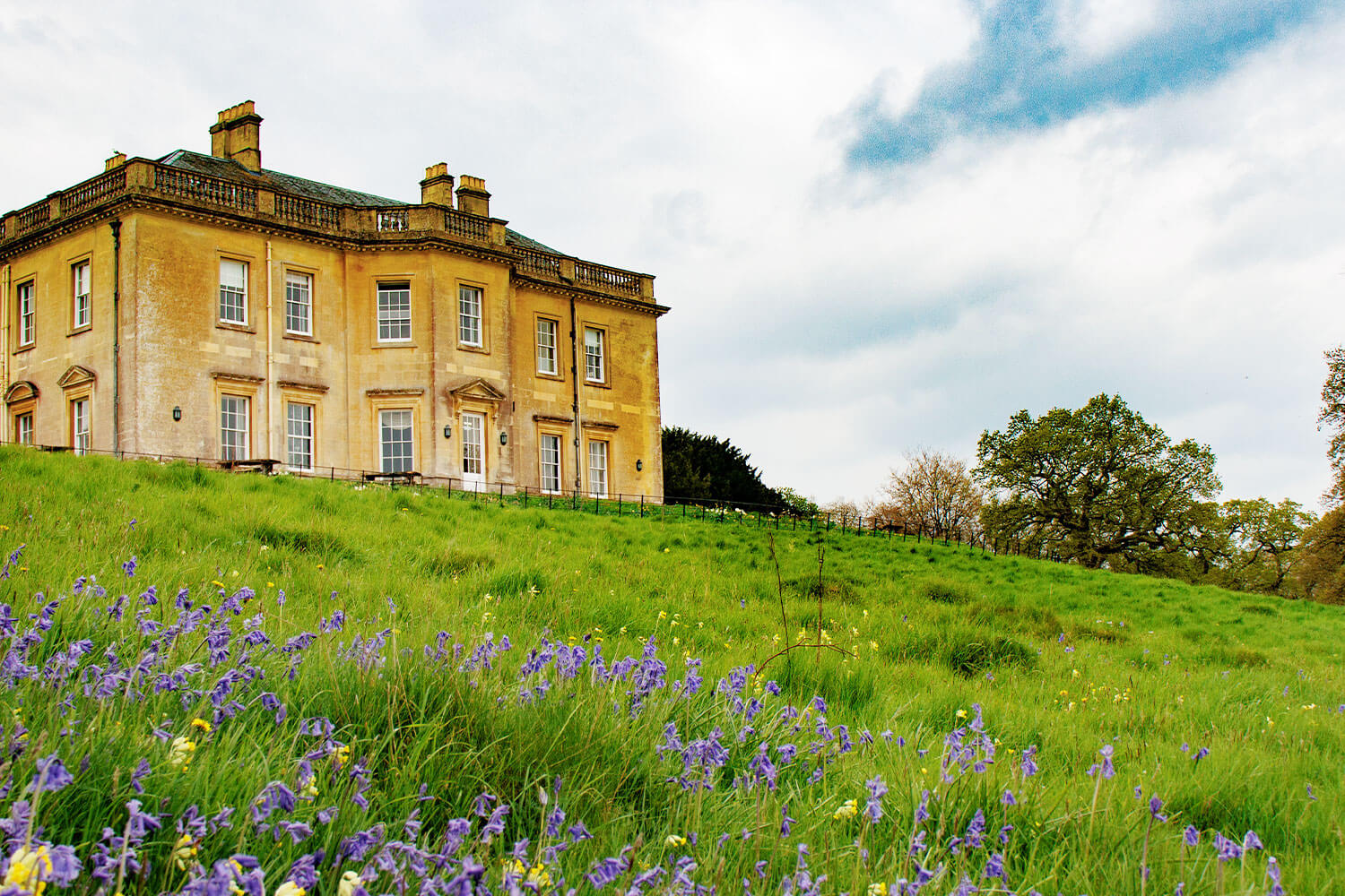 Eighteenth century building nestled in a field of spring flowers