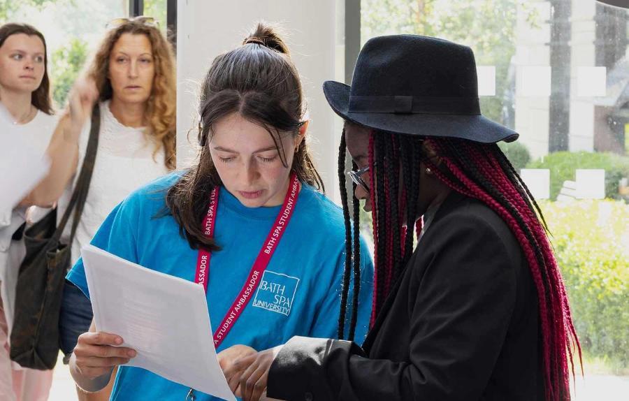 A Student Ambassador helps a visitor at an Open Day