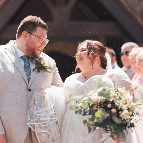 A couple hand in hand on their wedding day