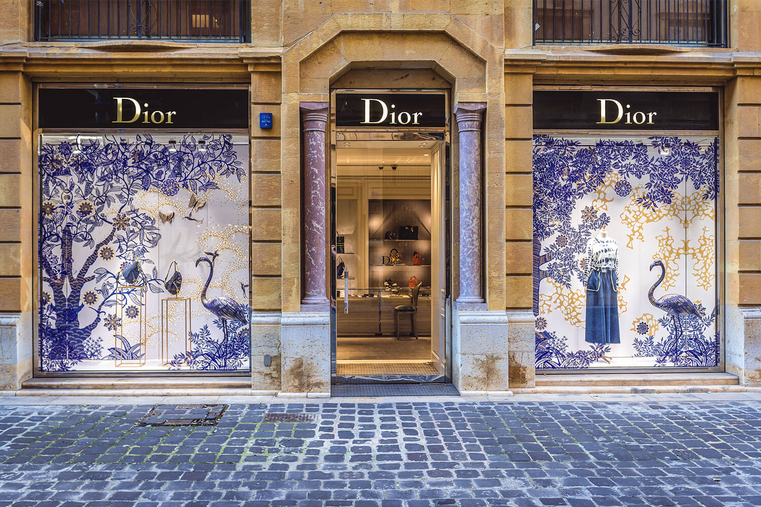 A photo of a dior shop on a cobbled street