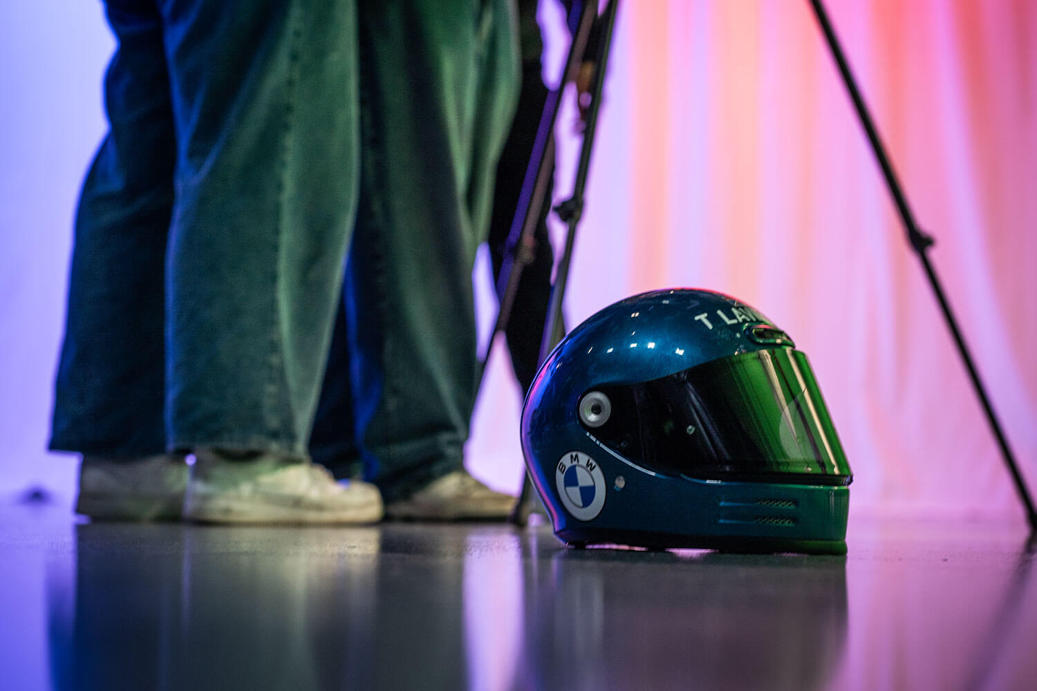 A bobsleigh helmet on the floor by a tripod leg