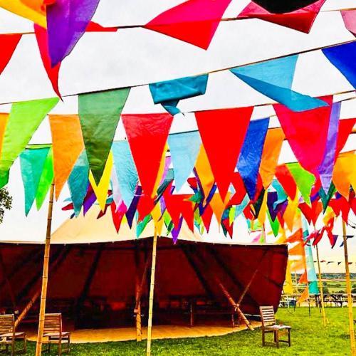 Colourful flags in front of a large gazebo 