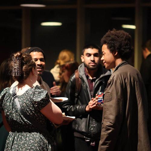 A group of people chatting at a networking function