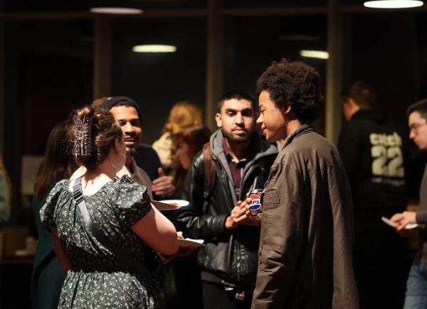 A group of people chatting at a networking function