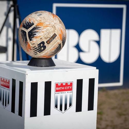 A football sat on a Bath City plinth with the Bath City logo behind