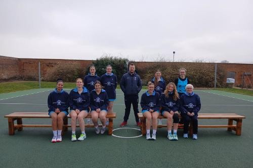 The BSU netball team poses with their new benches