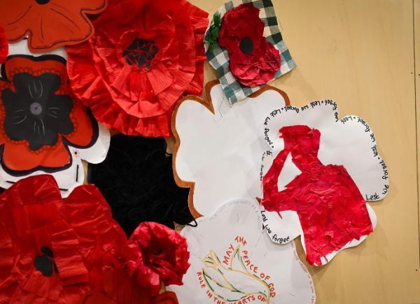 artwork inspired by the remembrance poppy displayed on a wooden wall