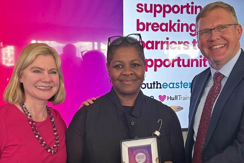 Dr Sharon Colilles poses with her award next to Justine Greening MP