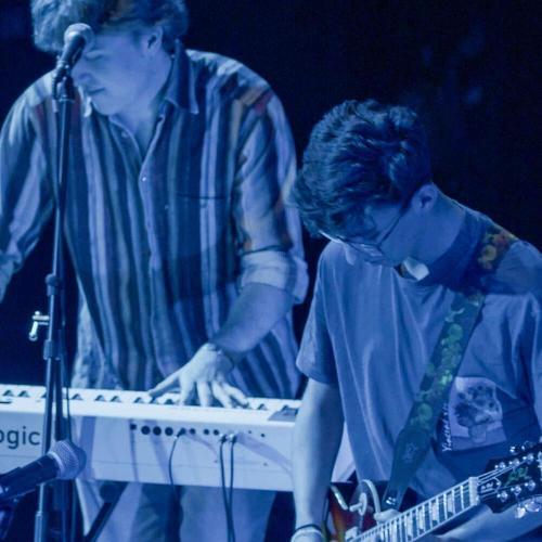 Two students playing guitar and keyboard