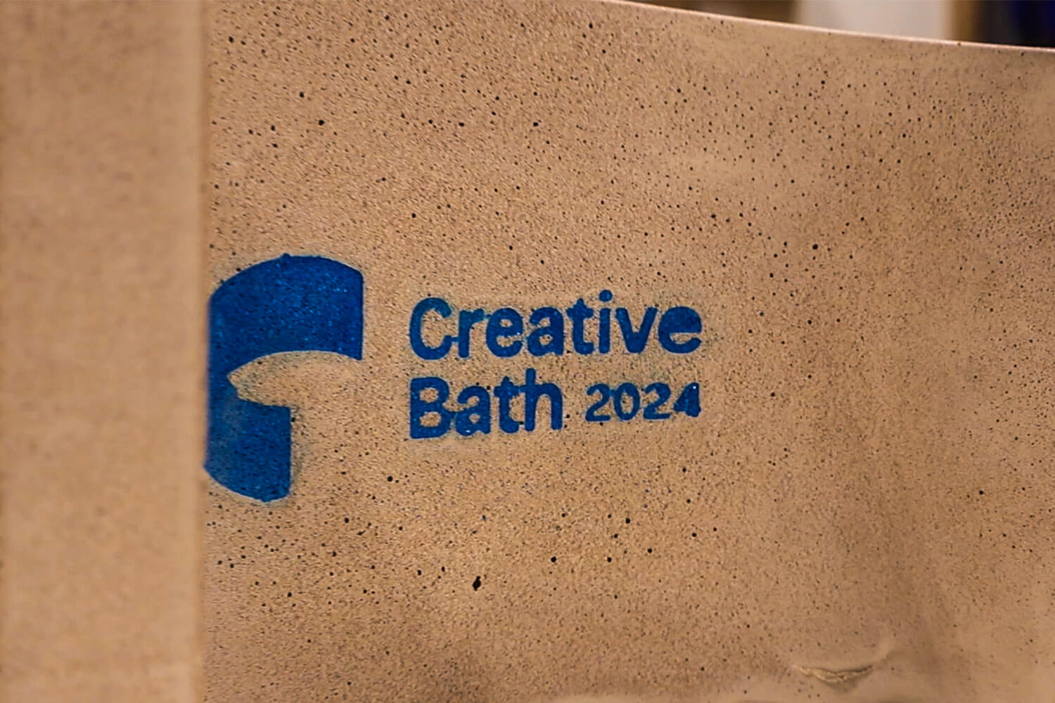 A slab of Bath Stone jesmonite with Creative Bath 2024 embossed