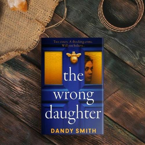 A book titled 'The Wrong Daughter' on a wooden table