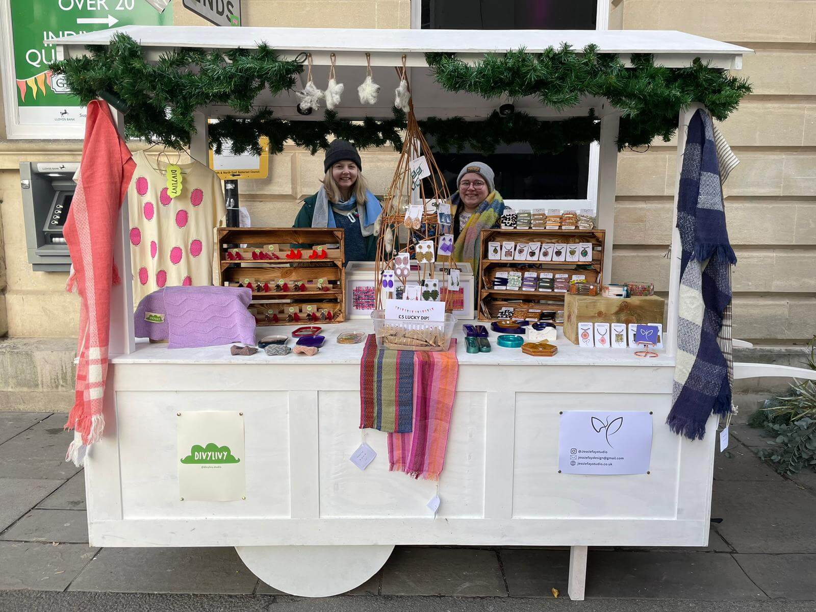 Two women stood selling artisan gifts at a Christmas market stall