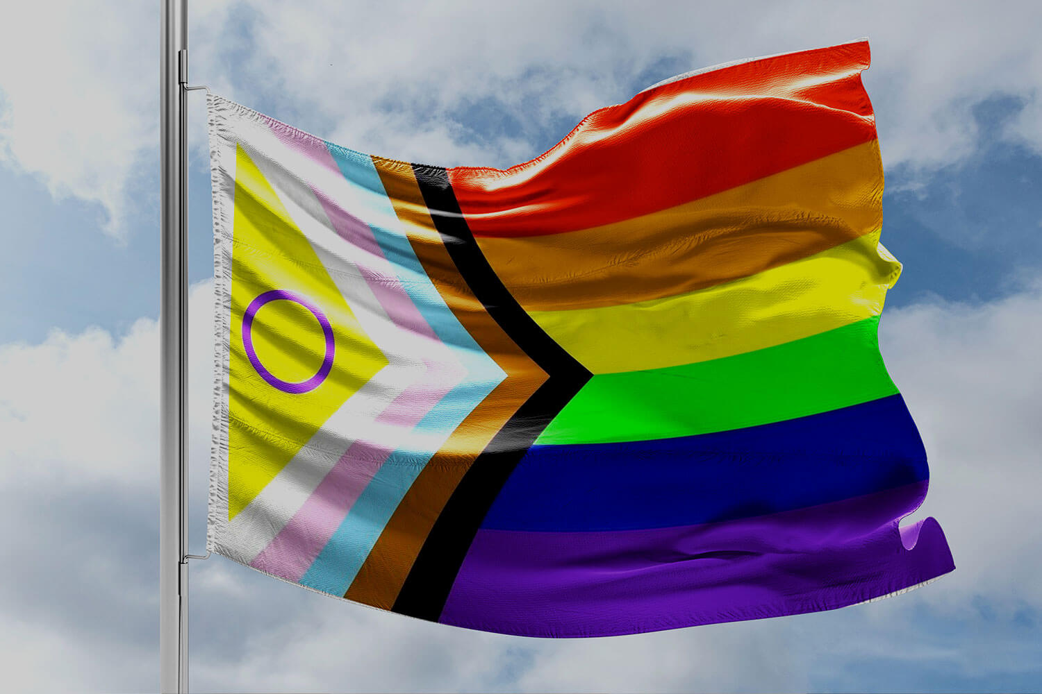 The Progress Pride flag fluttering in the breeze
