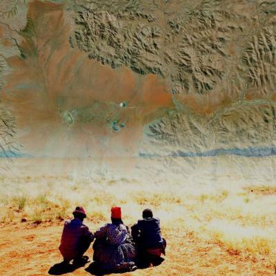 Three figures greet and gift their ancestors and anonymous spirits of the dead, looking across the Giribes plains towards their home area of Purros in west Namibia