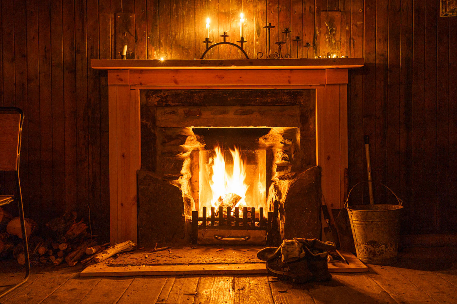 A lit fireplace surrounded by walking equipment