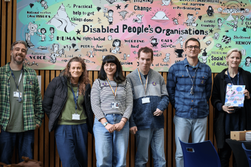 Members of the We Are The People team pose with the mural