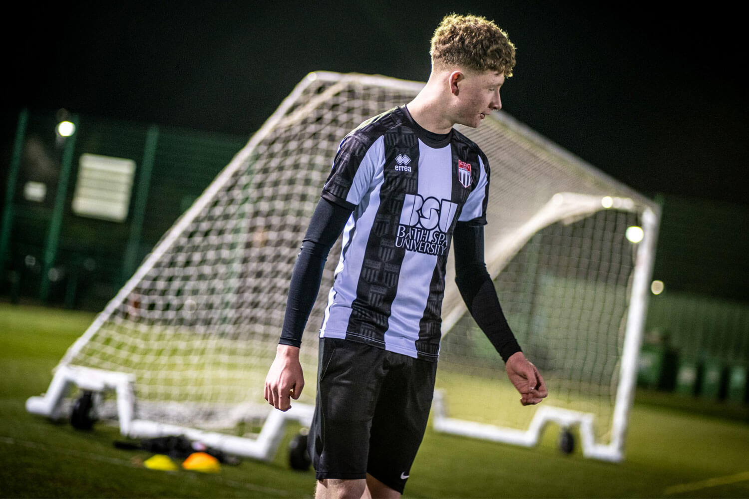 Young footballer wearing a Bath City + Bath Spa University shirt