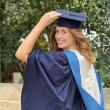 A person wearing BSU graduation robes poses for the camera