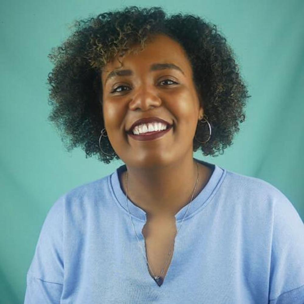 Photo of Belinda Clarke in front of a teal background