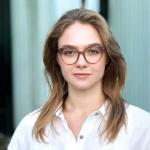 Woman in a white shirt wearing glasses