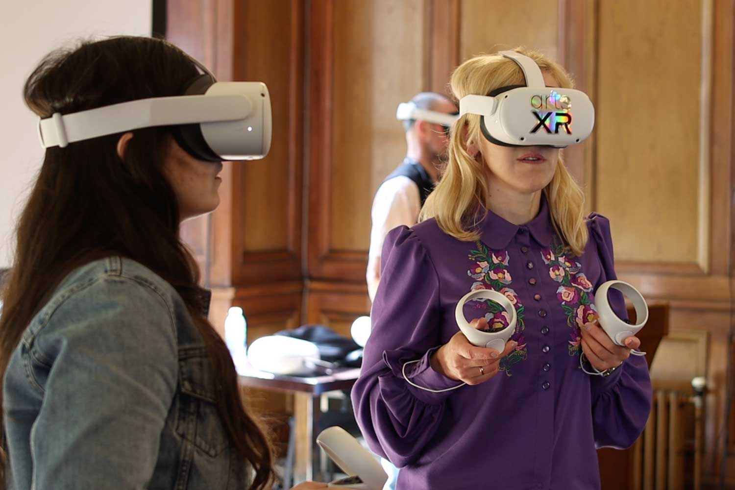 Three people wearing VR headsets take part in a workshop