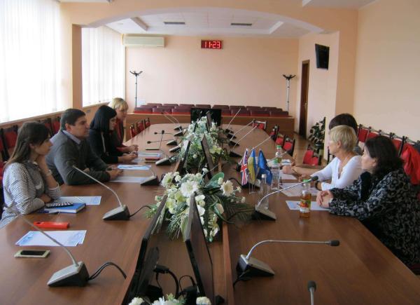Delegates gather around a boardroom table at Sumy State University in Ukraine