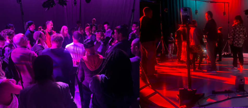A group of people in a dimly lit studio with red and purple toned lighting