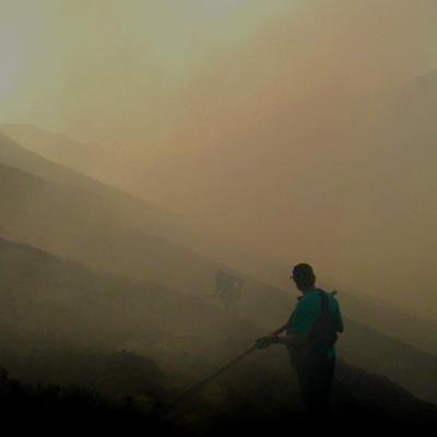 Firefighters on a smoky hillside