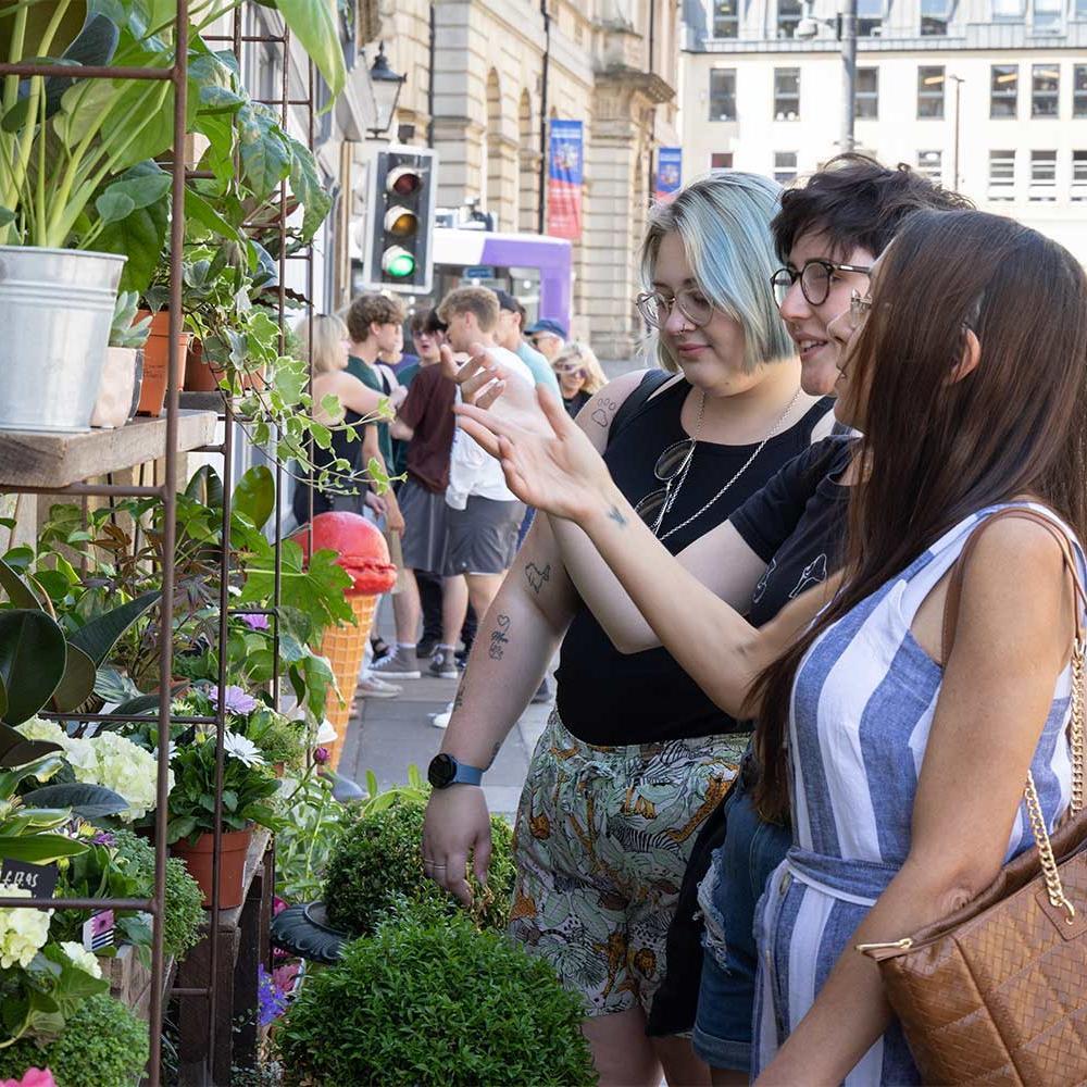 Group of young people in front of a plant display in Bath