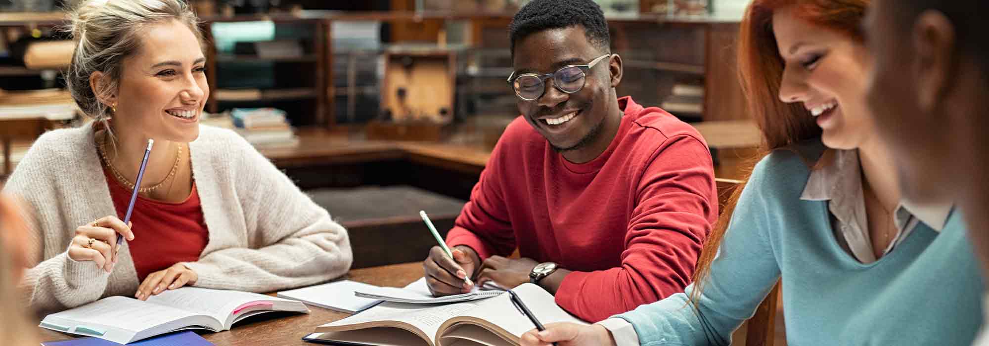 Group of young people studying and laughing