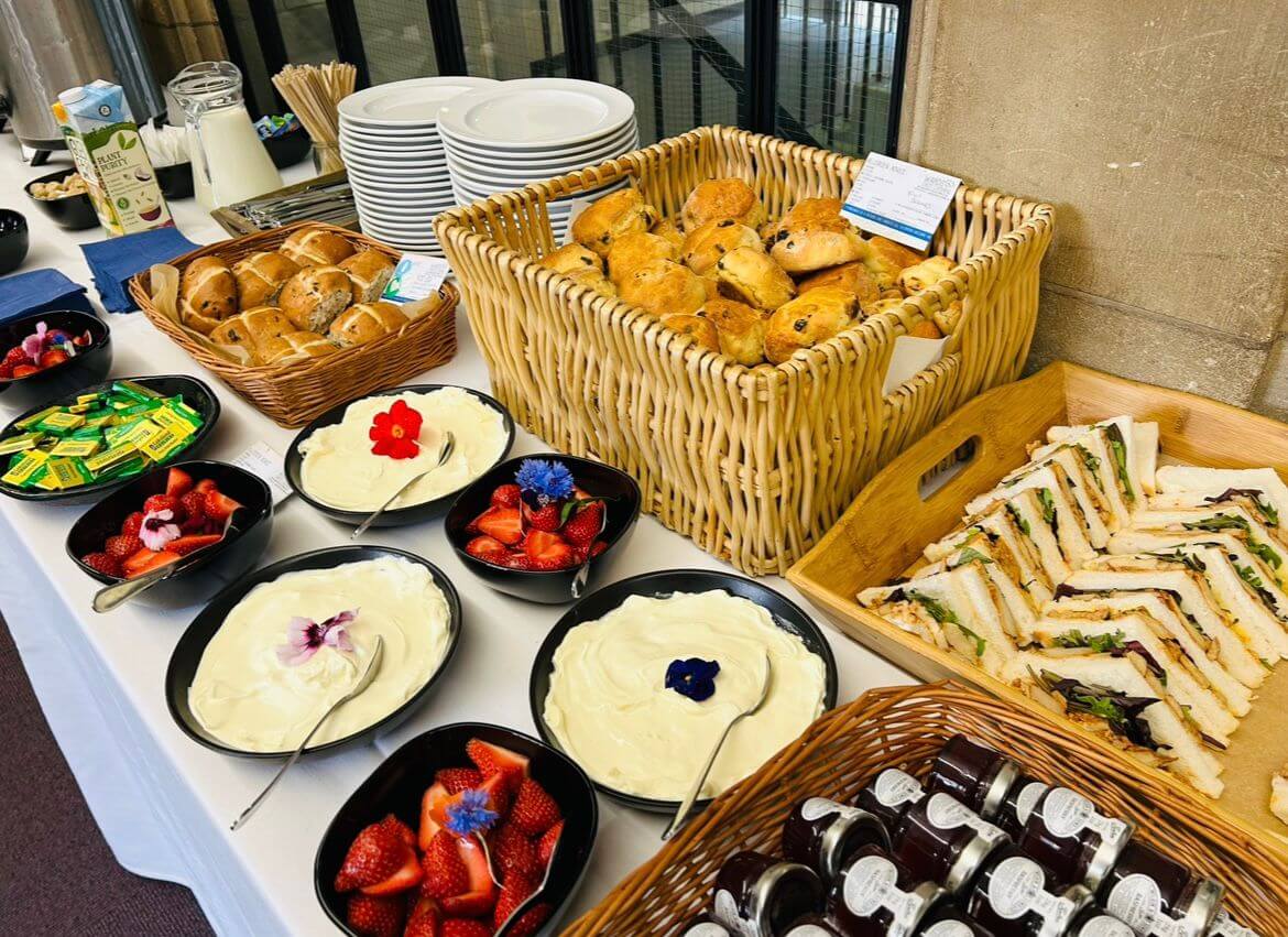 A buffet table with sandwiches and scones